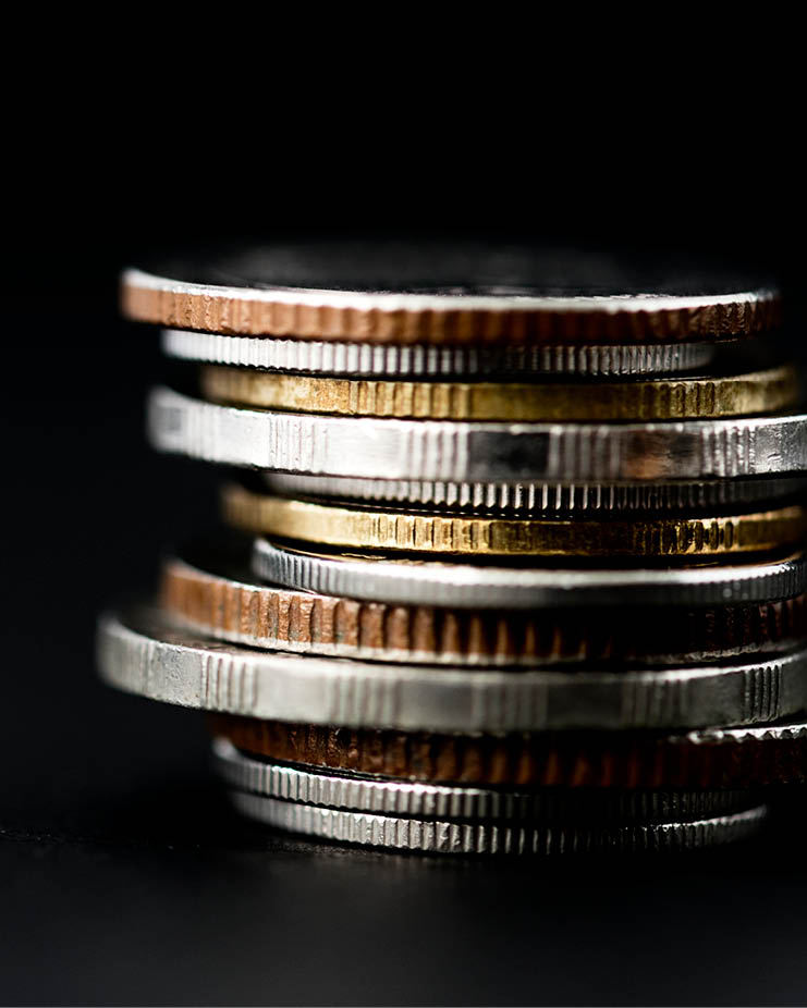 Closeup of coins stack isolated on black background