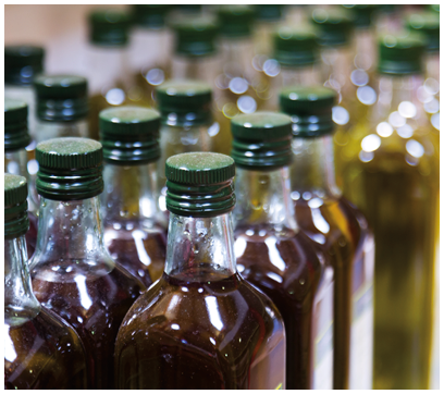 Bottles of olive oil on counter of  market