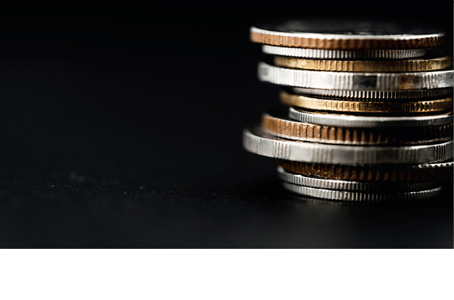Closeup of coins stack isolated on black background